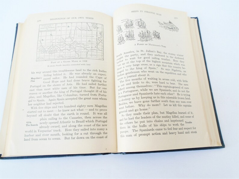 May include: A vintage book page with a black and white illustration of a map and text about the explorer Ferdinand Magellan's journey around the world. The text describes Magellan's travels and the challenges he faced, including the mutiny of his crew.