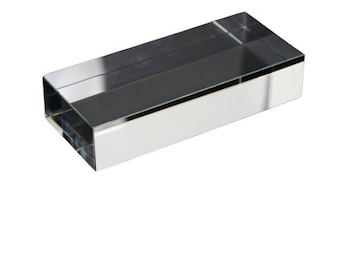 May include: A clear glass rectangular display stand. The stand is made of thick glass and has a polished finish.