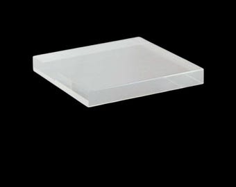 May include: A clear, square, frosted glass tray. The tray is made of thick glass and has a smooth, polished surface.