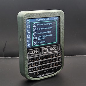May include: A green handheld device with a screen displaying "Meshtastic" and other data. It has a full keyboard labeled "LILYGO T-Keyboard". The screen shows "no new messages", "2 of 2 nodes online", and "LoRa 906.875 MHz".