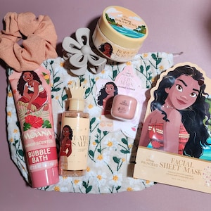 May include: A Disney Princess Moana themed beauty set including a floral print drawstring bag, a peach scrunchie, a grey hair claw, a mango scented bubble bath tube, bath salts, a coconut scented lip mask, a body scrub, and a facial sheet mask.