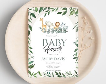 May include: Baby shower invitation featuring a watercolor illustration of a giraffe, elephant, lion, and rhino. The invitation has a green leaf border and includes the text "Baby Shower" and details for Avery Davis.