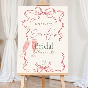 Cartello di benvenuto modificabile per addio al nubilato: design con nastro rosa e champagne (modello Canva, download immediato)