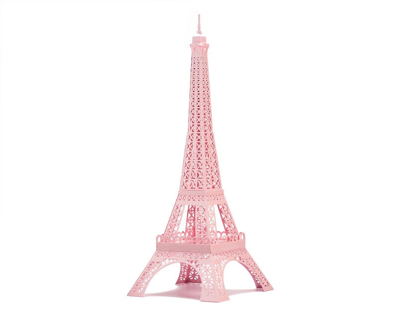 Pink-colored 3d paper scale model of the Eiffel Tower, made out of pre-cut paper parts.