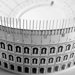 Assembled 3d scale model of the Roman Colosseum. The model of the ancient oval amphitheatre is made out of printed paper parts, the graphics feature external wall colonades and corridors and the inside with tiers of seats.