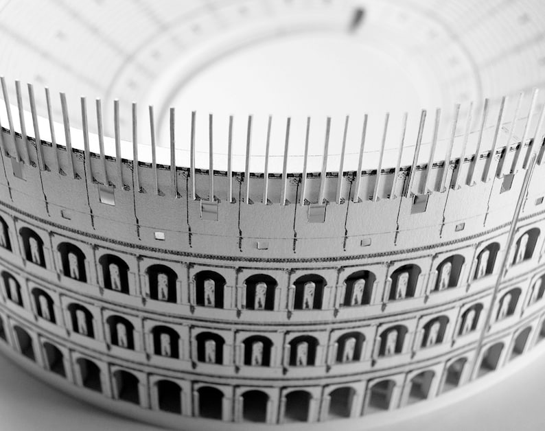 Assembled 3d scale model of the Roman Colosseum. The model of the ancient oval amphitheatre is made out of printed paper parts, the graphics feature external wall colonades and corridors and the inside with tiers of seats.