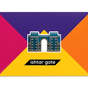 Product packaging for the Ishtar Gate paper model kit. A rectangular bright coloured cardstock envelope features four large triangles in yellow, magenta, purple and orange with an image of a finished model at the centre and the product title below.