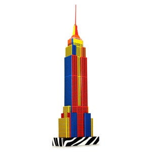 Assembled 3d paper model of the Empire State building of New York. The skyscraper model is made out of pre-cut cardboard parts and design features unusual colors: black and white base, vertical red, yeallow and blue strips on it's facade.