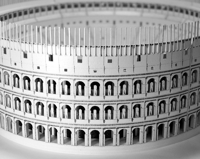 Assembled 3d scale model of the Roman Colosseum. The model of the ancient oval amphitheatre is made out of printed paper parts, the graphics feature external wall colonades and corridors and the inside with tiers of seats.