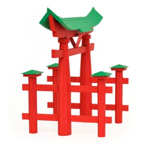 Assembled 3d scale model of the Torii Gate, the symbolic gateway which marks the entrance to the Itsukushima Shrine on the island of Miyajima in Japan. The model is made out of red and green paper.