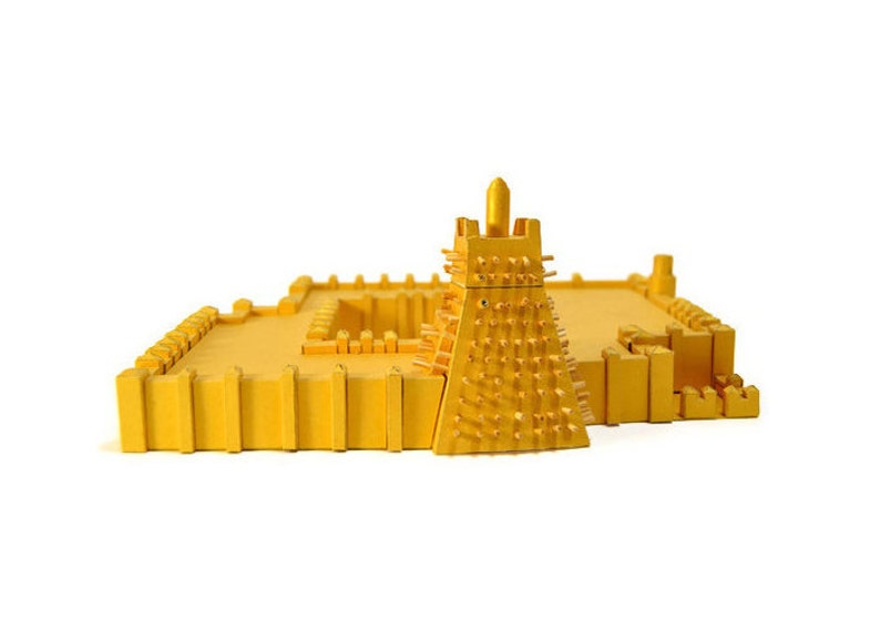 Assembled 3d scale model of the Sankoré Mosque, one of three ancient learning centers located in Timbuktu, Mali. The model is made out of golden paper parts, it features the pyramidal mihrab and inner courtyard.