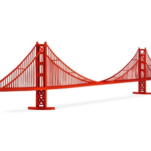 Diagonal view of the assembled 3d scale model of the Golden Gate bridge, made out of bright red die-cut cardstock parts. The model features two art-deco style bridge towers, a deck and cables.