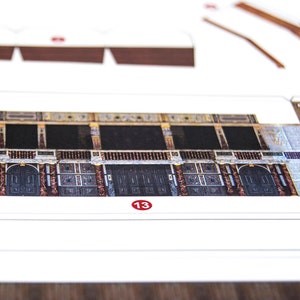 Close-up of a printed paper sheet with cut-out parts for building the Globe Theatre scale model from the PaperLandmarks kit.