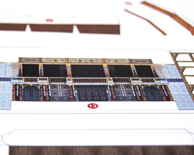 Close-up of a printed paper sheet with cut-out parts for building the Globe Theatre scale model from the PaperLandmarks kit.