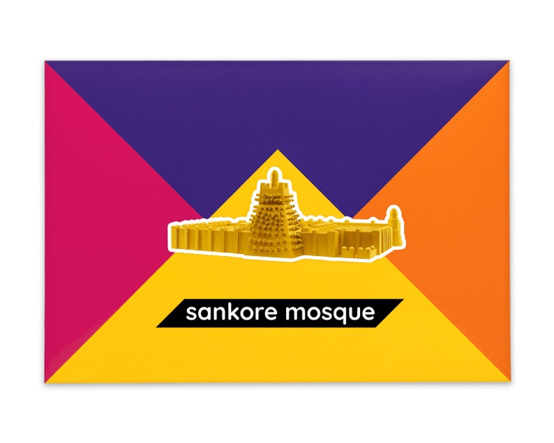 Product packaging for the Sankore Mosque paper model kit. A recangular bright coloured cardstock envelope features four large triangles in yellow, magenta, purple and orange with an image of a finished model at the centre and the product title below.