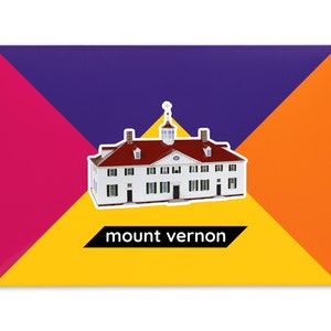 Product packaging for the Mount Vernon paper model kit. A rectangular bright coloured cardstock envelope features four large triangles in yellow, magenta, purple and orange with an image of a finished model at the centre and the product title below.