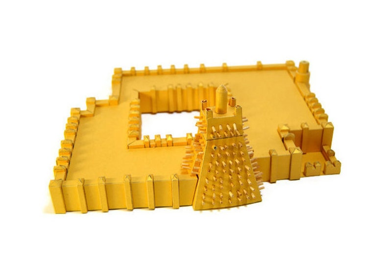 Assembled 3d scale model of the Sankoré Mosque, one of three ancient learning centers located in Timbuktu, Mali. The model is made out of golden paper parts, it features the pyramidal mihrab and inner courtyard.