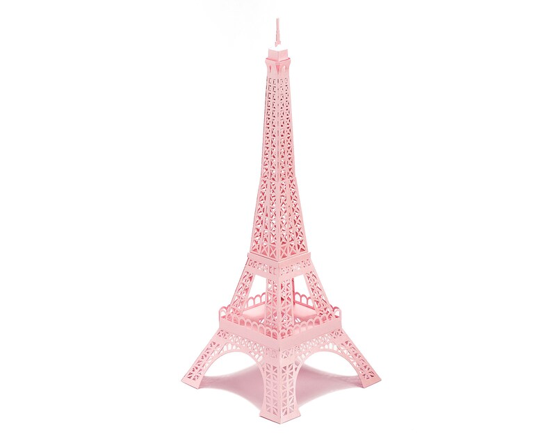Pink-colored 3d paper scale model of the Eiffel Tower, made out of pre-cut paper parts.