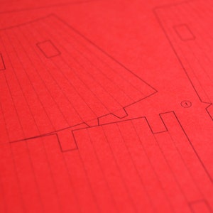 Closeup of the paper worksheet with printed parts to be cut out for making a scale model of the Torii Gate.