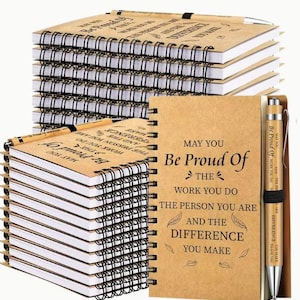 May include: A stack of 20 kraft paper notebooks with black wire-o binding. Each notebook has a motivational quote printed on the cover. The quote reads "May you be proud of the work you do, the person you are, and the difference you make". A bamboo pen with the same quote is included.