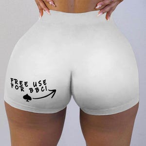 May include: White athletic shorts with the text "FREE USE FOR BBCI" in black, along with a spade symbol and an arrow. The shorts are made of a stretchy material.