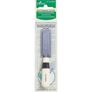 May include: A white and gray buttonhole cutter with a black handle. The cutter is labeled "Buttonhole Cutter" and "Art No. 484/W".