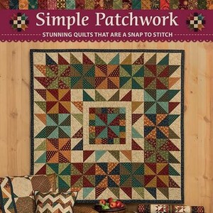 May include: A book titled "Simple Patchwork: Stunning Quilts That Are A Snap To Stitch" by Kim Diehl. The cover features a colorful patchwork quilt with a brown wooden background.