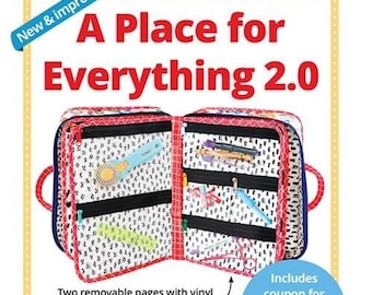 May include: A Place for Everything 2.0 organizer bag, open to display interior pockets and removable pages. The bag is red, white, and blue with a colorful pattern. Includes a coupon for a video tutorial. The bag has handles and a detachable strap.