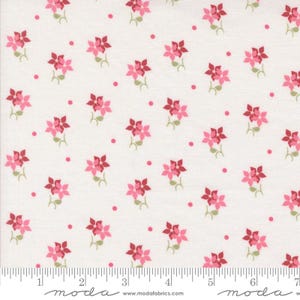 May include: White fabric with a repeating pattern of pink and dark red flowers and small pink dots. The flowers have green stems and leaves. The fabric has a ruler along the bottom with the word "moda" and the website address.