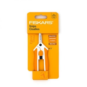 May include: Orange and white Fiskars fabric snips on a bright orange product card. The card features the Fiskars logo, the words "Snips" and "Cisailles", and the text "Easy Action" and "Micro-Tip". The snips are designed for fabric cutting.