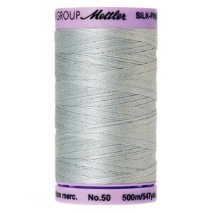 May include: A spool of Mettler Silk-Finish thread in a light gray color. The spool is labeled "Mettler Silk-Finish" and "No. 50".