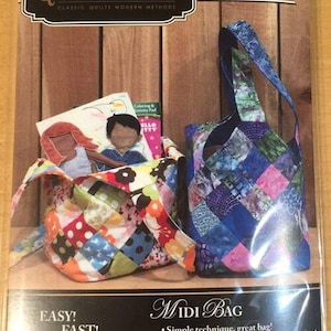 May include: A package for a Midi Bag sewing project. The package features two finished patchwork bags in bright colors. The text on the package reads "Quiltsmart" and "Easy! Fast! Smart!"