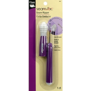May include: Purple seam ripper with a white plastic top. The packaging says "seam-fix" Seam Ripper, Corta Costuras, Cuts threads, Grabs & erases threads, Agarra y borra hilos, Corta hilos, 1 ct.