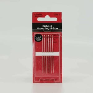 May include: A package of six size 7 Long Darner needles by Richard Hemming & Son. The red and black packaging features the brand name, needle count, and a small eagle emblem. The needles are visible through a clear plastic window.