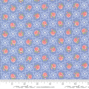 May include: A light blue fabric with a repeating pattern of pink roses and white scrollwork. The fabric has a ruler along the bottom edge and the Moda Fabrics logo.