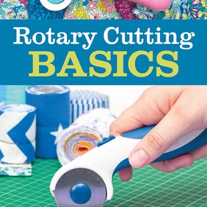 May include: A book titled "Rotary Cutting Basics: A Beginner's Guide to Sizes, Types, Techniques, Troubleshooting, Mats, Rulers, Safety & More" with a pink and blue rotary cutter on the cover.