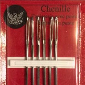 May include: A package of six Richard Hemming & Son size 18 chenille needles. The packaging is red with black text, featuring the brand name, needle type, and a logo of a bird. The needles are silver, metallic, and held in place by a white strip.