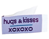 Tag It Ons - Hugs & Kisses - 12 tags per packet. 1-1/8" x 5/8" - Little tags that can be attached to your quilts and crafts - Little labels