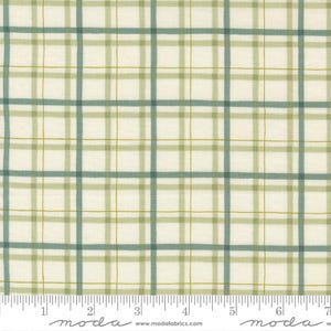 May include: Cream-colored fabric with a plaid pattern in shades of green and blue. The grid-like design features varying widths of lines, creating a textured appearance. A ruler is at the bottom of the image.