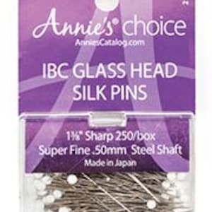 May include: A package of 250 white glass head silk pins with a super fine 50mm steel shaft. The package is labeled "Annie's Choice IBC Glass Head Silk Pins 1 1/2" Sharp 250/box Super Fine 50mm Steel Shaft Made in Japan".