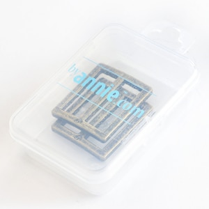 May include: Two antique gold metal belt buckle slides in a clear plastic package. The package has a label that says "by annie.com".