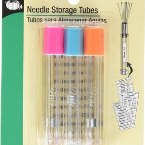 May include: A package of Dritz needle storage tubes. The package contains three clear tubes with pink, blue, and orange caps. The text on the package reads "Needle Storage Tubes" and "3 tubes/33 labels."