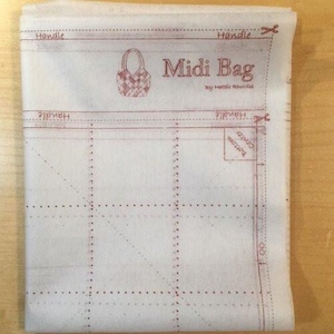 May include: A white fabric pattern for a Midi Bag, featuring red printed lines and text. The design includes a bag illustration, labeled sections for handles, and the text "Midi Bag" and "Bottom Center".