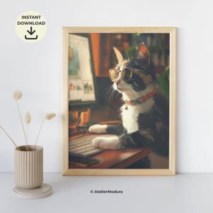 May include: A framed wall art print featuring a black, white, and brown cat wearing round gold-rimmed glasses and a red collar, sitting at a desk with a computer and keyboard. The print is housed in a light-colored wooden frame.