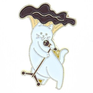 May include: A white cat enamel pin with a microphone, singing under a brown and yellow mushroom. The pin has gold-colored metal accents. The cat is smiling and holding the microphone.
