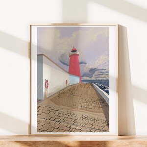 May include: Framed art print of a red lighthouse on a stone pier. The lighthouse stands tall against a cloudy sky, with a white wall and life preservers on the left. The pier leads to the sea.