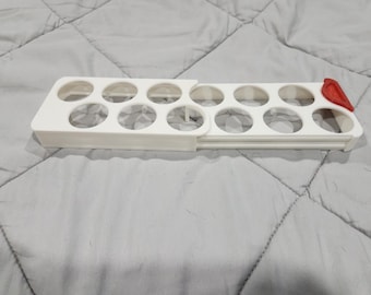 retractable egg tray holder for refrigerator shelf or a door.