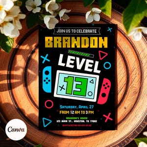 May include: A black and yellow birthday invitation with a video game theme. The invitation says "Join us to celebrate Brandon Level 13" with a graphic of a video game controller and a game screen. The invitation includes the date, time, and location of the party.
