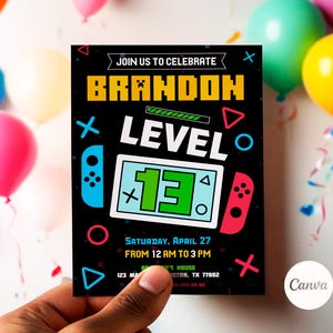 May include: A black and colorful invitation for a birthday party. The invitation features a video game controller with the text "JOIN US TO CELEBRATE BRANDON LEVEL 13" and the date "SATURDAY, APRIL 27 FROM 12 AM TO 3 PM".