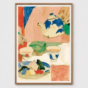 May include: A framed art print featuring a painterly illustration of a white teapot with blue patterns pouring liquid into a cup. The scene includes a green bowl, a patterned teacup, and a plate with colourful geometric shapes on a table.